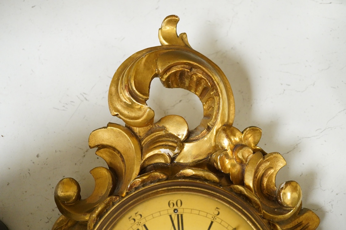 A carved giltwood cartel wall clock, 57 cm high